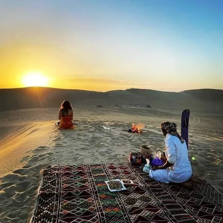 Pícnic y pequeña hoguera en las dunas de Siwa al atardecer